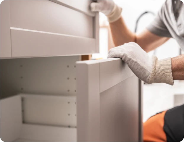 Carpenter installing updated cabinets in a bathroom